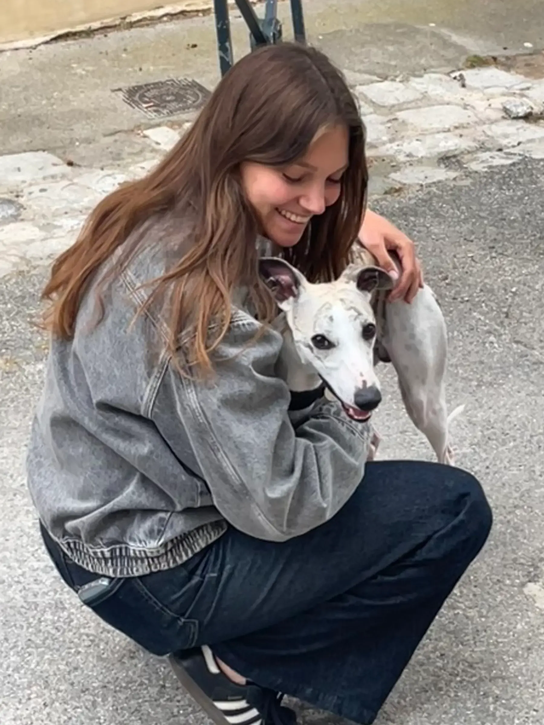 Emily hugging a whippet